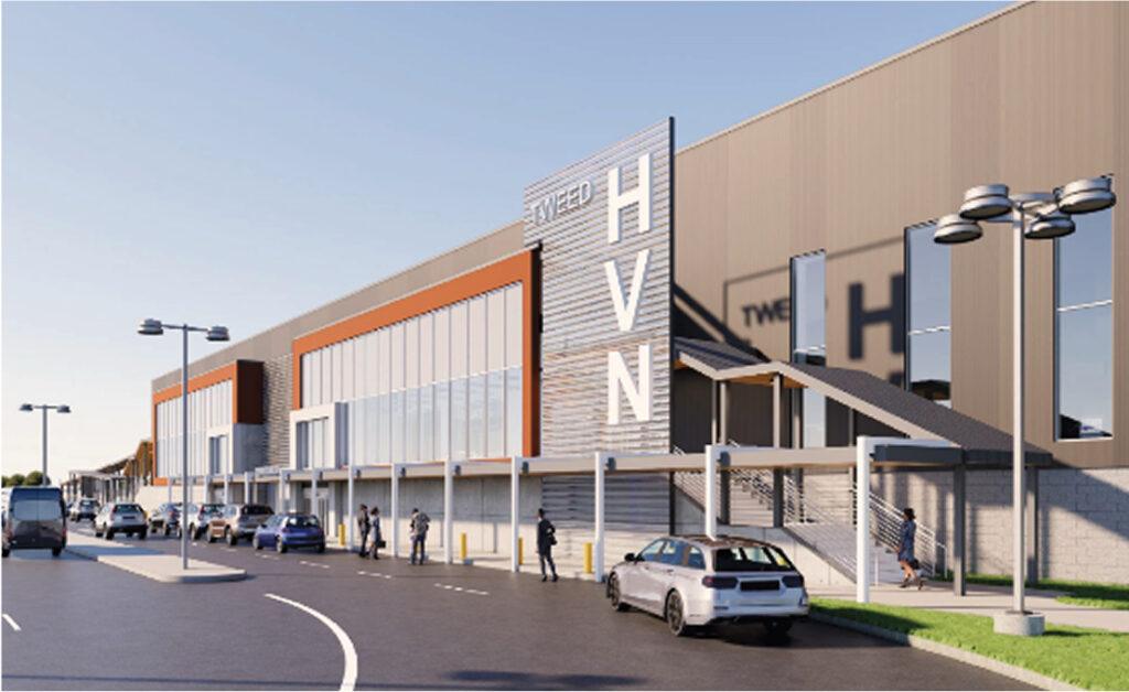 2024 - Photograph of a parking lot in the foreground and a Breeze airplane on a runway in the background